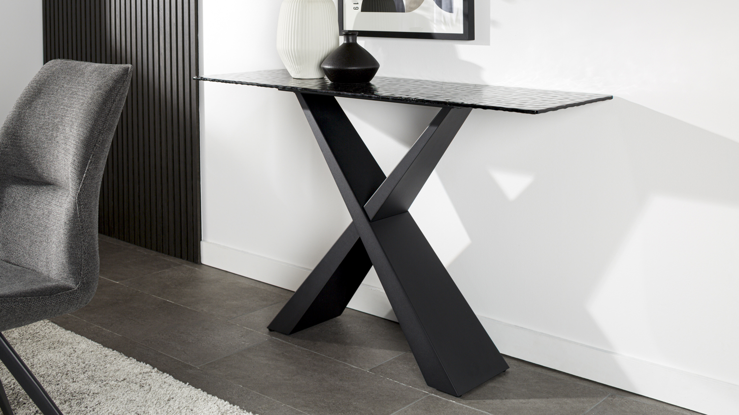 Lumicera console table with a rippled black glass top and X-shaped black metal base