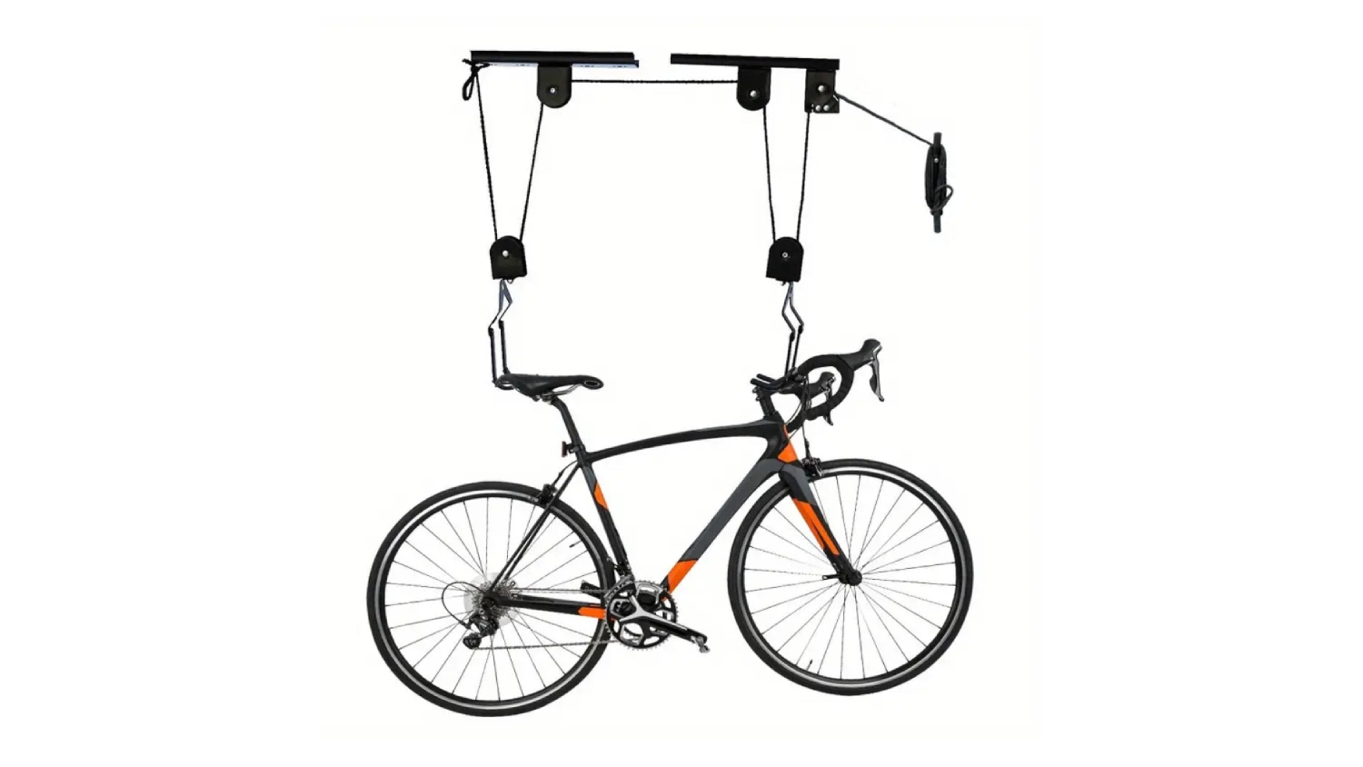 A road bicycle is suspended from a ceiling by a black pulley hoist system with straps attached to the seat and handlebars