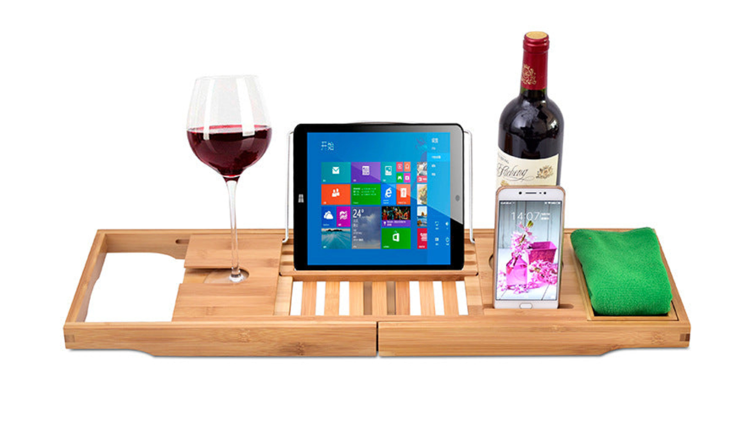 Expandable bamboo bathtub caddy tray holding a wine glass, tablet, smartphone, towel, and wine bottle