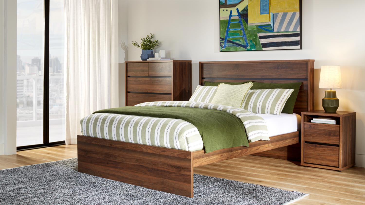 Finn Walnut finish bed frame in styled bedroom setting.