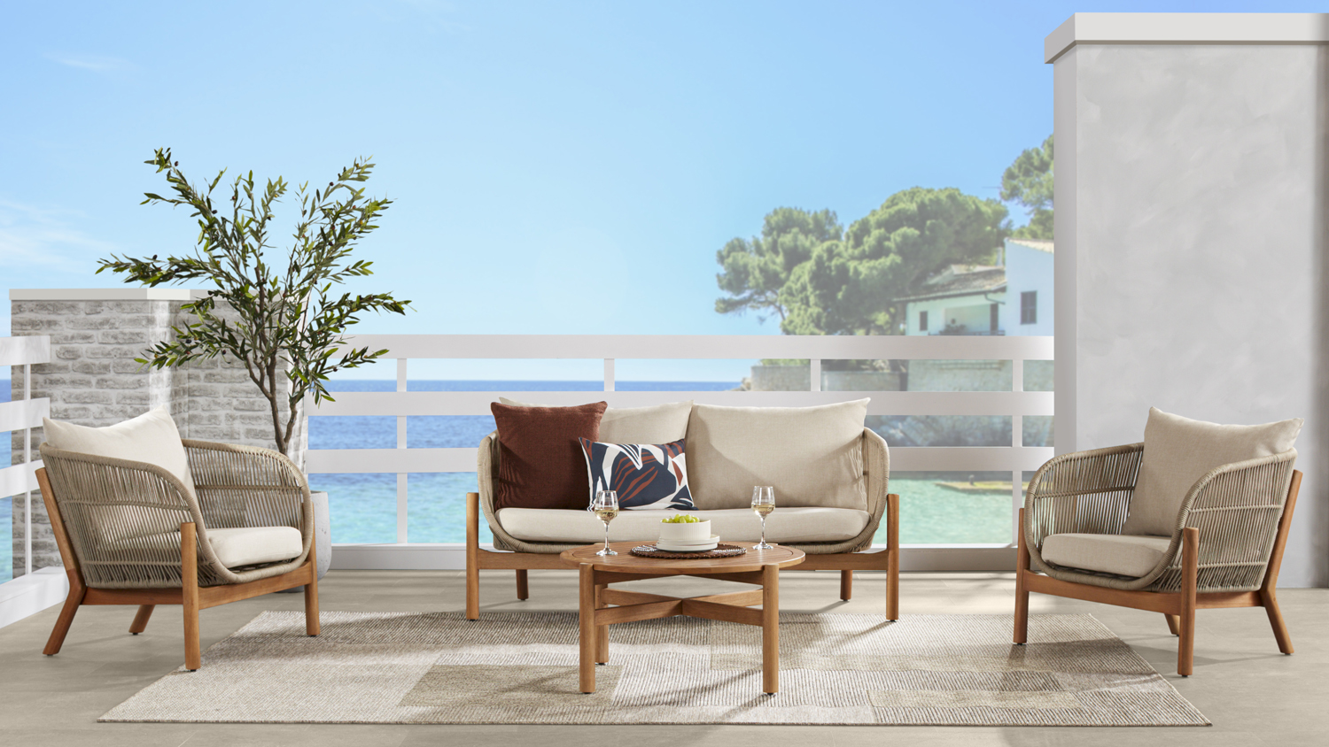 A wooden-framed outdoor lounge set with a sofa, two chairs, and a round coffee table.