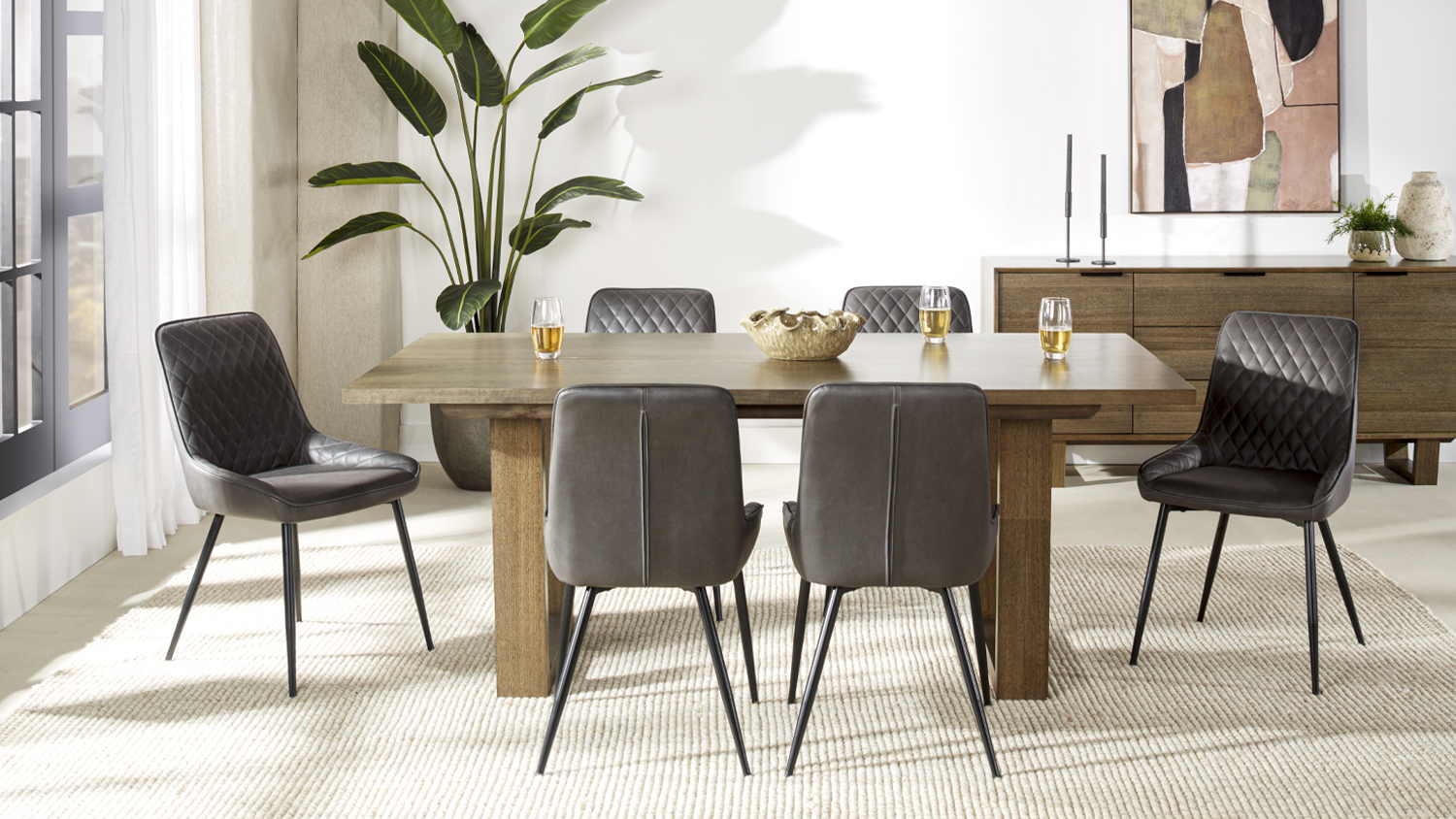 Whitehaven 7 Piece Dining Suite with a rectangular wooden table and six cushioned chairs on a light textured rug