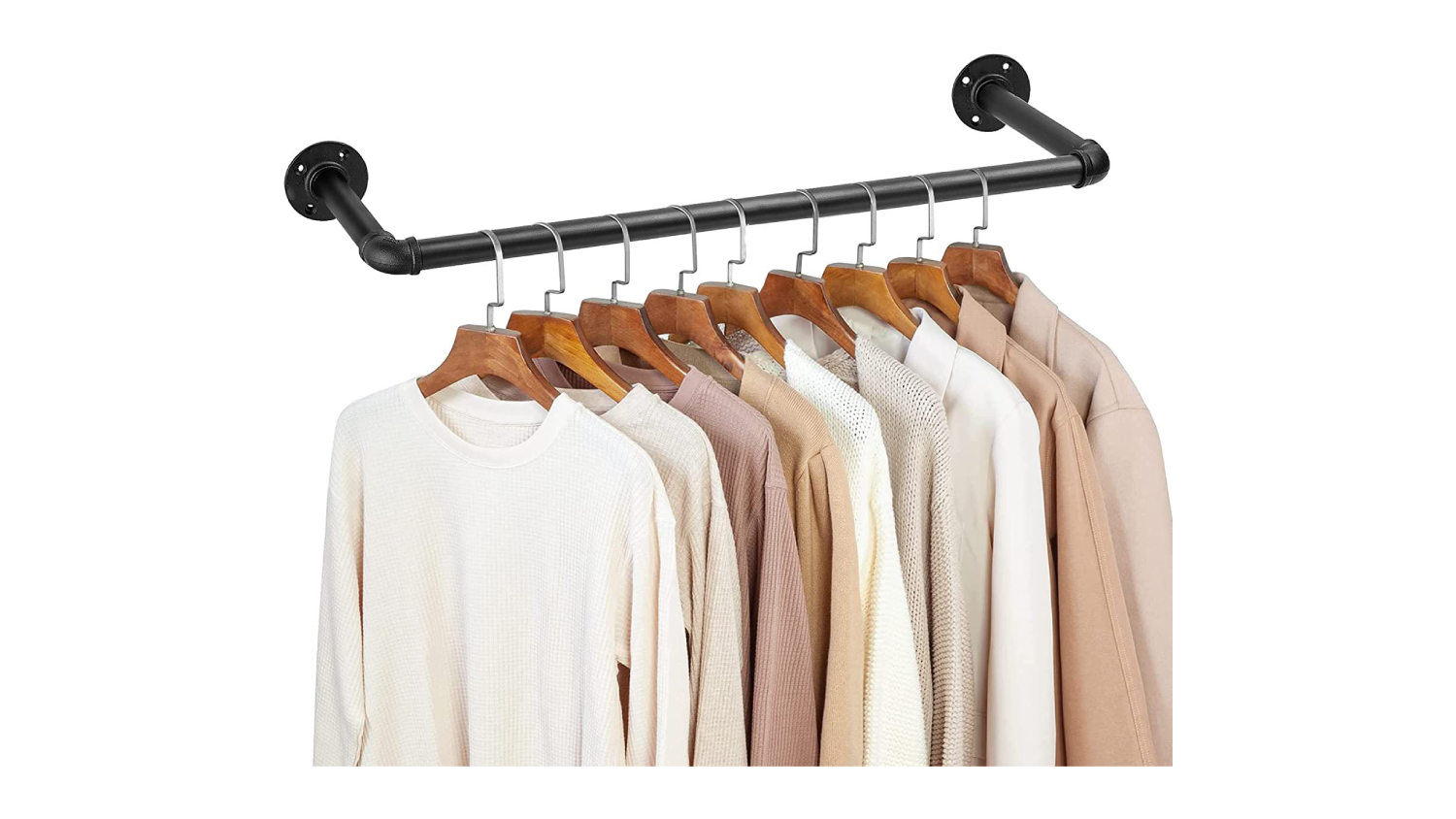 Wall-mounted black industrial pipe clothes rack holding wooden hangers with neutral-coloured shirts