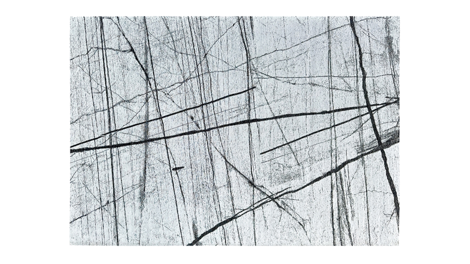 Rectangular rug with a white base and abstract black line pattern resembling marble veining
