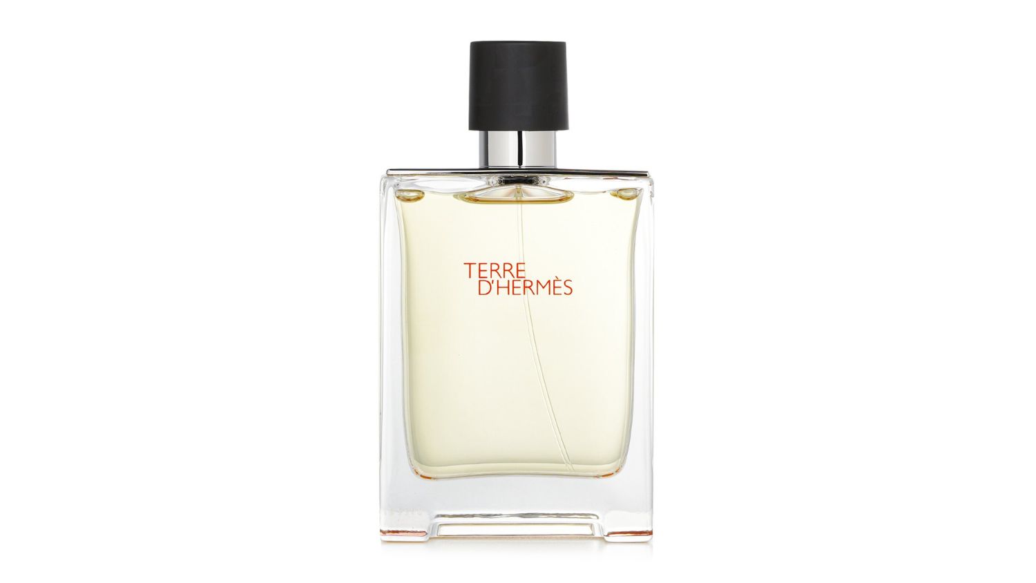 Clear glass bottle of Hermès Terre d’Hermès Eau de Toilette with black cap and orange text on front