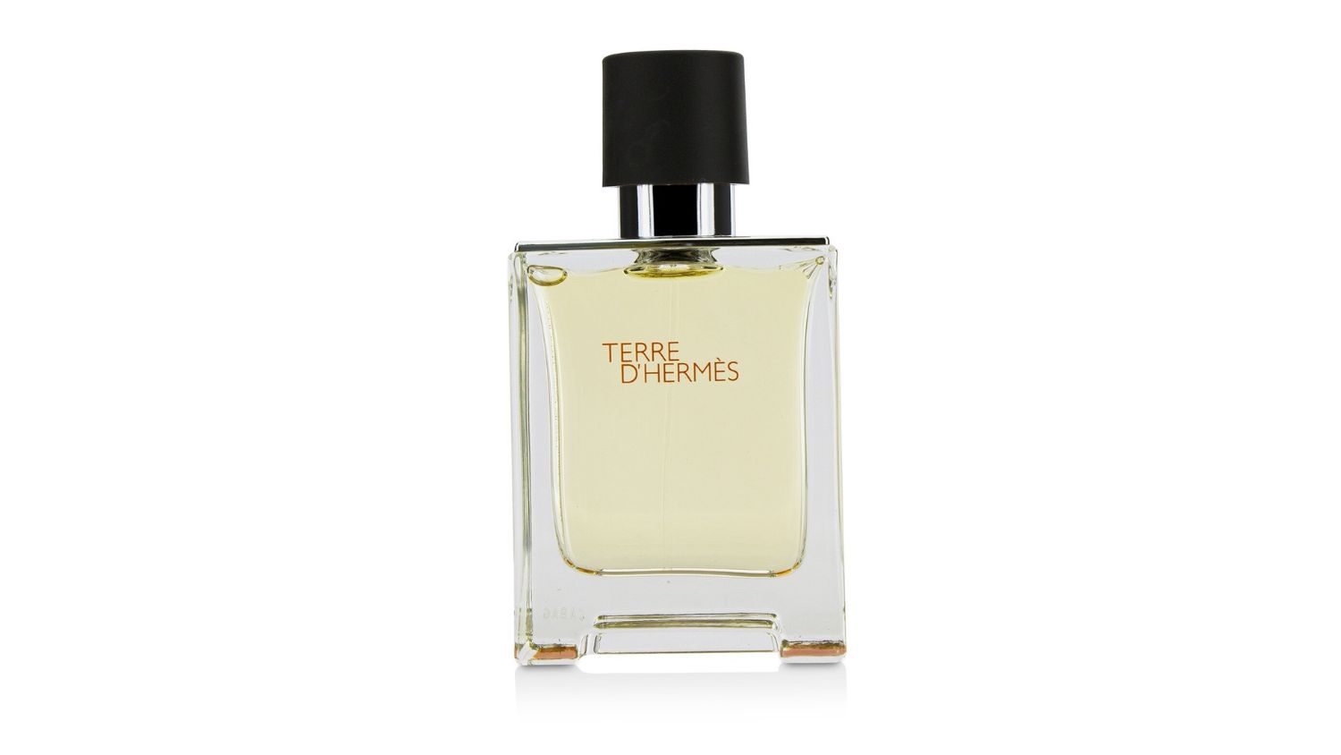 Clear glass bottle of Hermès Terre d’Hermès Eau de Toilette with black cap and orange text on front