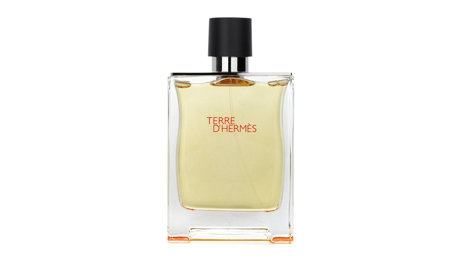 Clear glass bottle of Hermès Terre d’Hermès Eau de Toilette with black cap and orange text on front