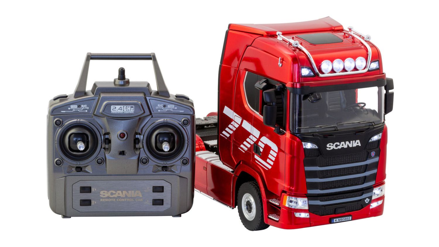 Red Scania RC truck with detailed cab design next to a black remote control