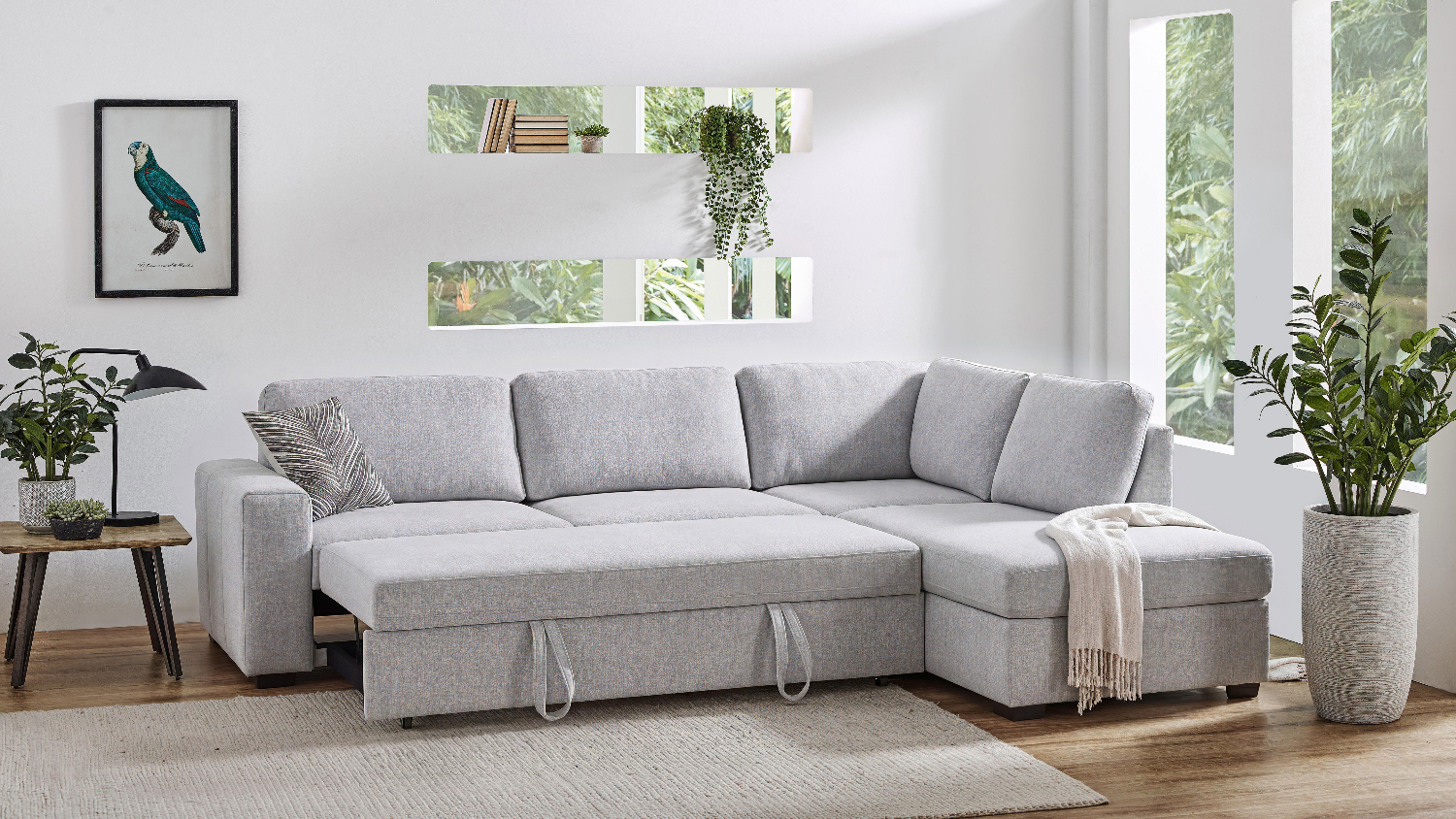 Convertible light gray corner sofa showing the hidden bed unit pulled out to create a roomy sleeping surface