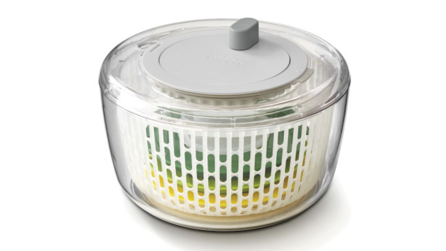 A clear salad spinner with a grey lid and an inner white basket