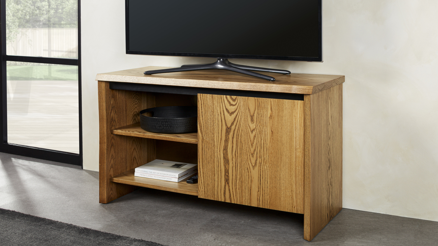 Raglan Entertainment Unit with a natural wood finish, featuring an open shelf on one side and a door on the other