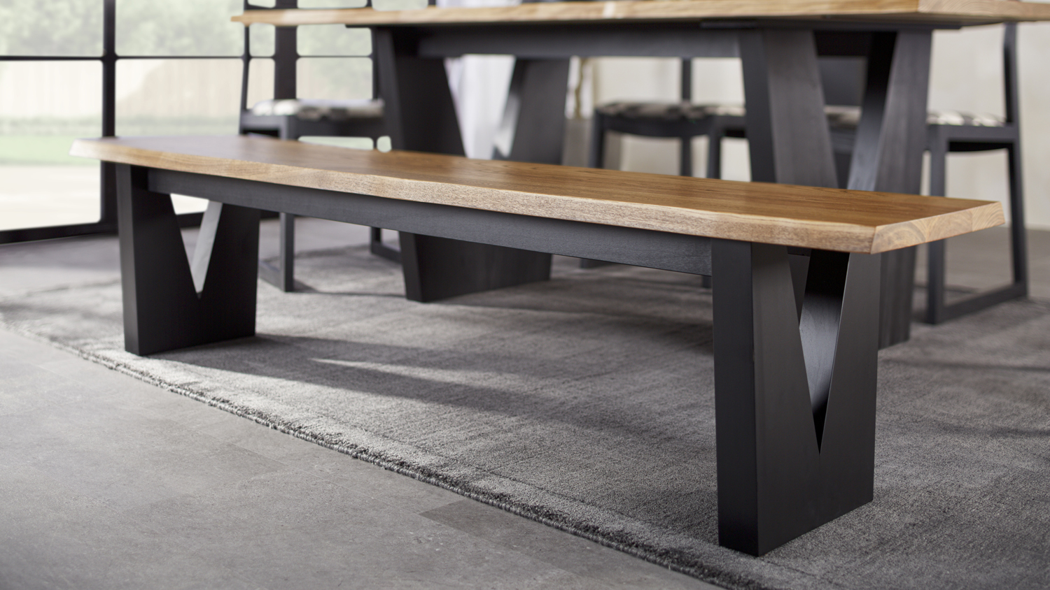 Raglan Dining Bench with a natural wood seat and black V‑shaped legs, shown in a dining room setup