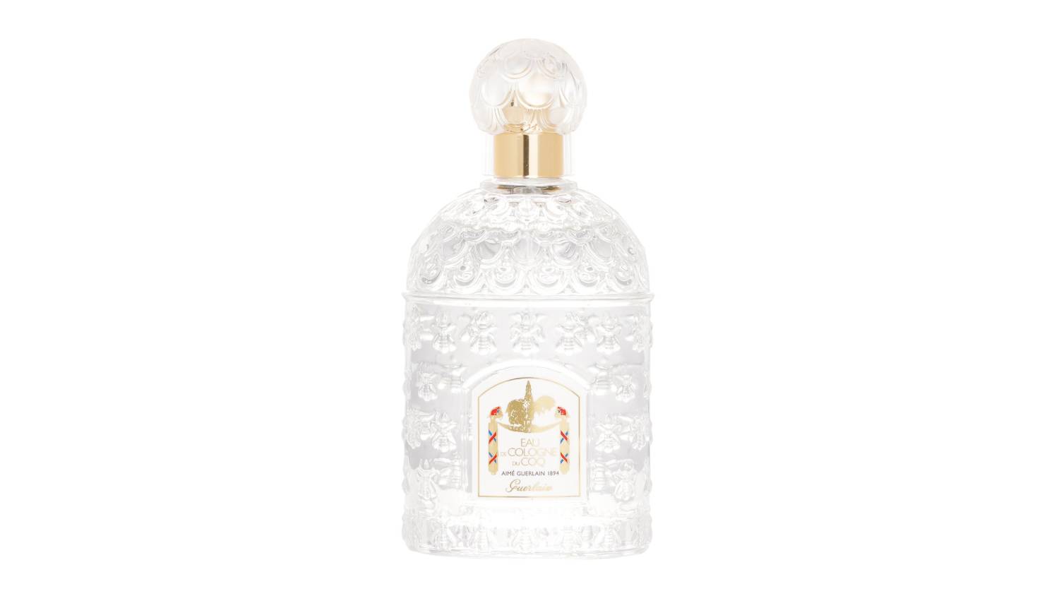 Clear Guerlain Du Coq Eau De Cologne bottle with ornate embossed design, gold neck, and round textured cap