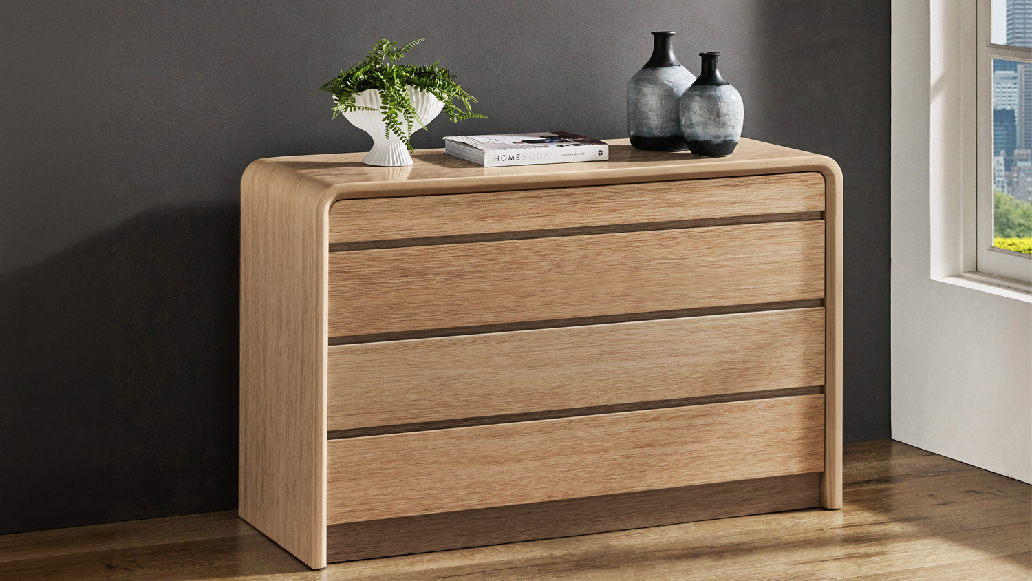 Arc 4 Drawer Lowboy in light oak with rounded edges and decorative vases on top