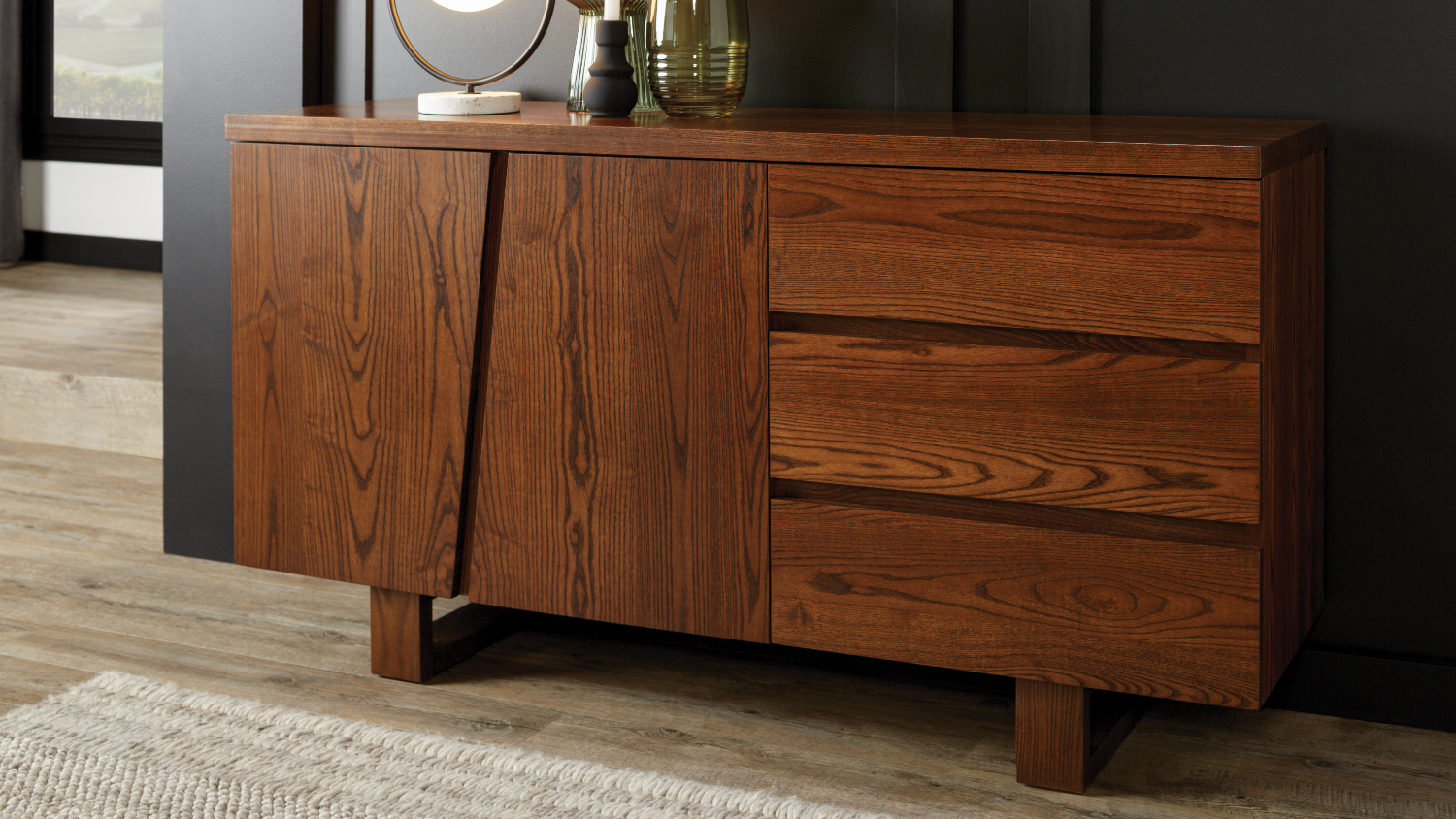 A Haast Buffet Table made of warm-toned wood is shown in a modern interior