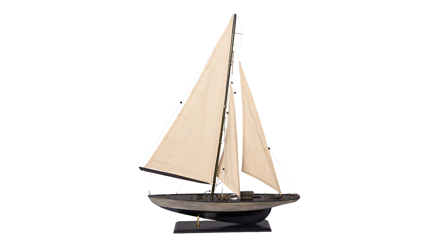 A large wooden model yacht with a dark brown hull, deck fittings, and beige fabric sails, displayed on a black stand