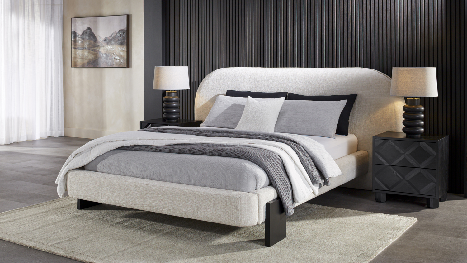 An Opal King Upholstered Bed Frame against a black slatted wall