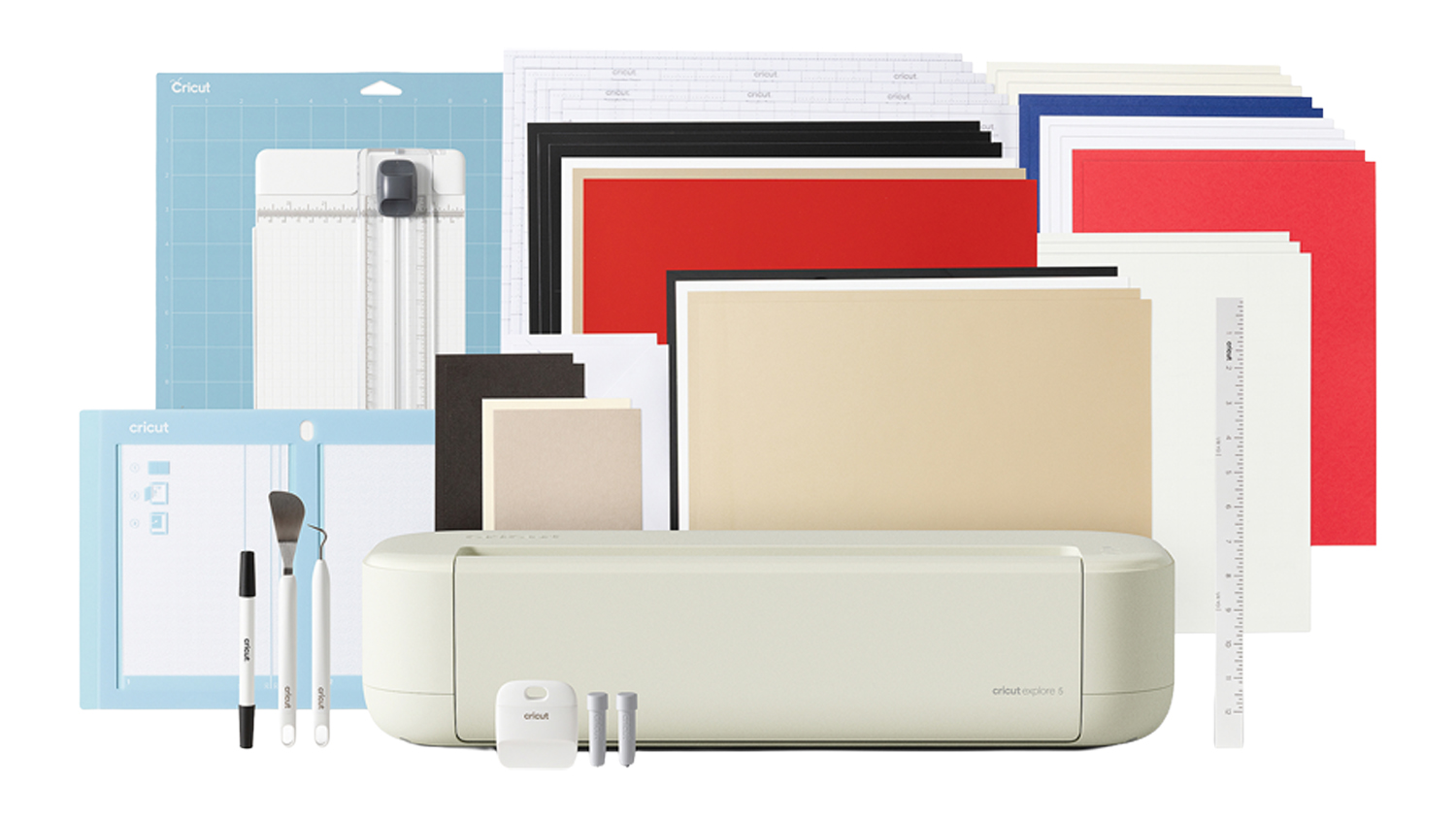 Cricut Explore 5 Essential Bundle displayed with accessories and assorted sheets of cardstock