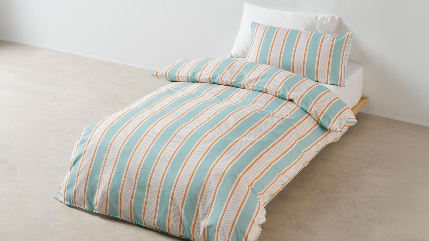 Sailor Stripe Blue Duvet Cover Set by Linen House Kids on a low wooden bed in a bright room