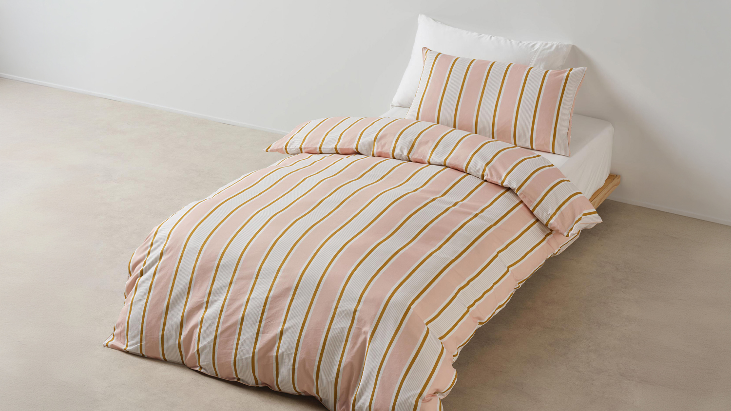 Sailor Stripe Pink Duvet Cover Set by Linen House Kids on a single bed in a bright room
