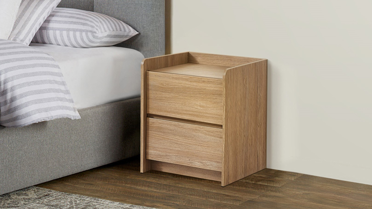 Front view of the Chelsea 2 Drawer Bedside Table in sand oak, featuring a simple rectangular design