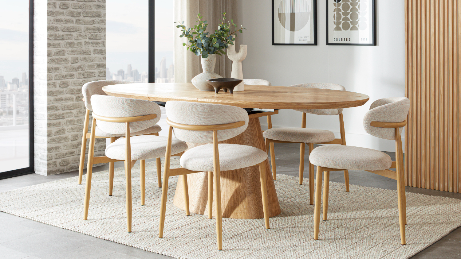 The Ryder 7 Piece Dining Suite featuring an oval wooden table and six matching cream upholstered chairs in a bright room