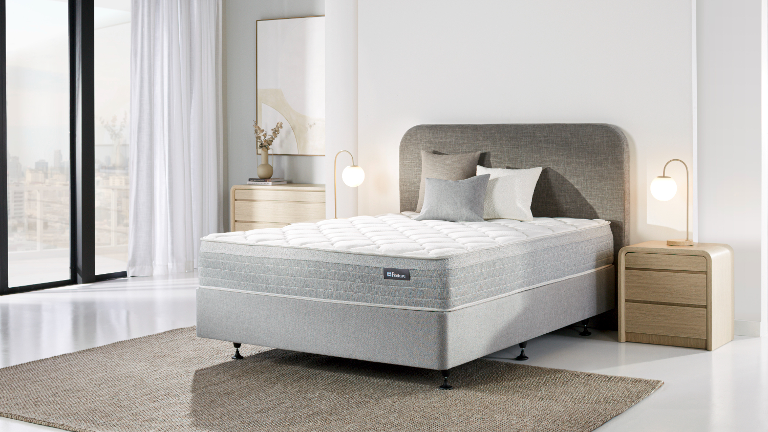 Bedroom scene showing the Posture Life Medium King Mattress on a bed base