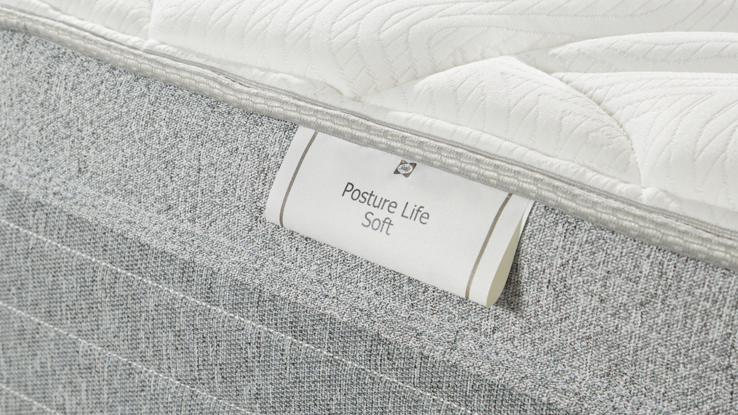 Detailed close‑up of the side label reading “Posture Life Soft,” showing the mattress fabric texture