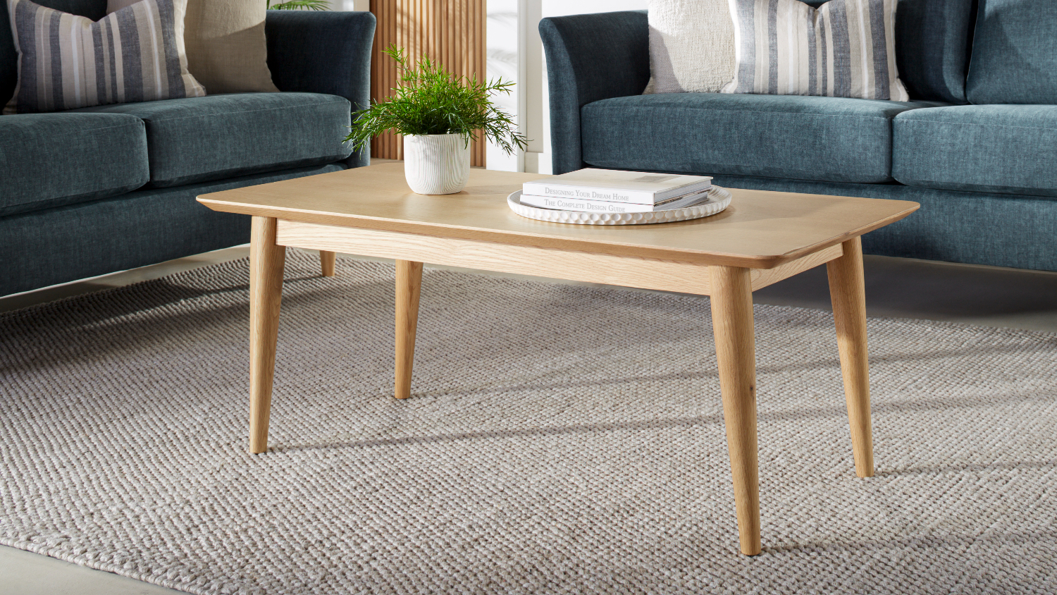 Rectangular Helsinki 1150mm coffee table in light oak, styled in a modern living room