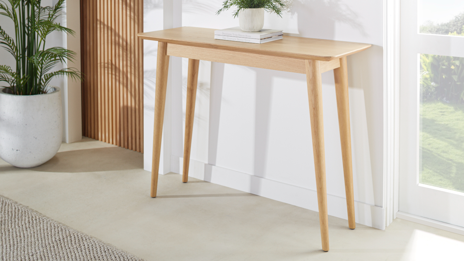 Helsinki 1060mm hall table in light oak positioned against a wall in a bright entryway