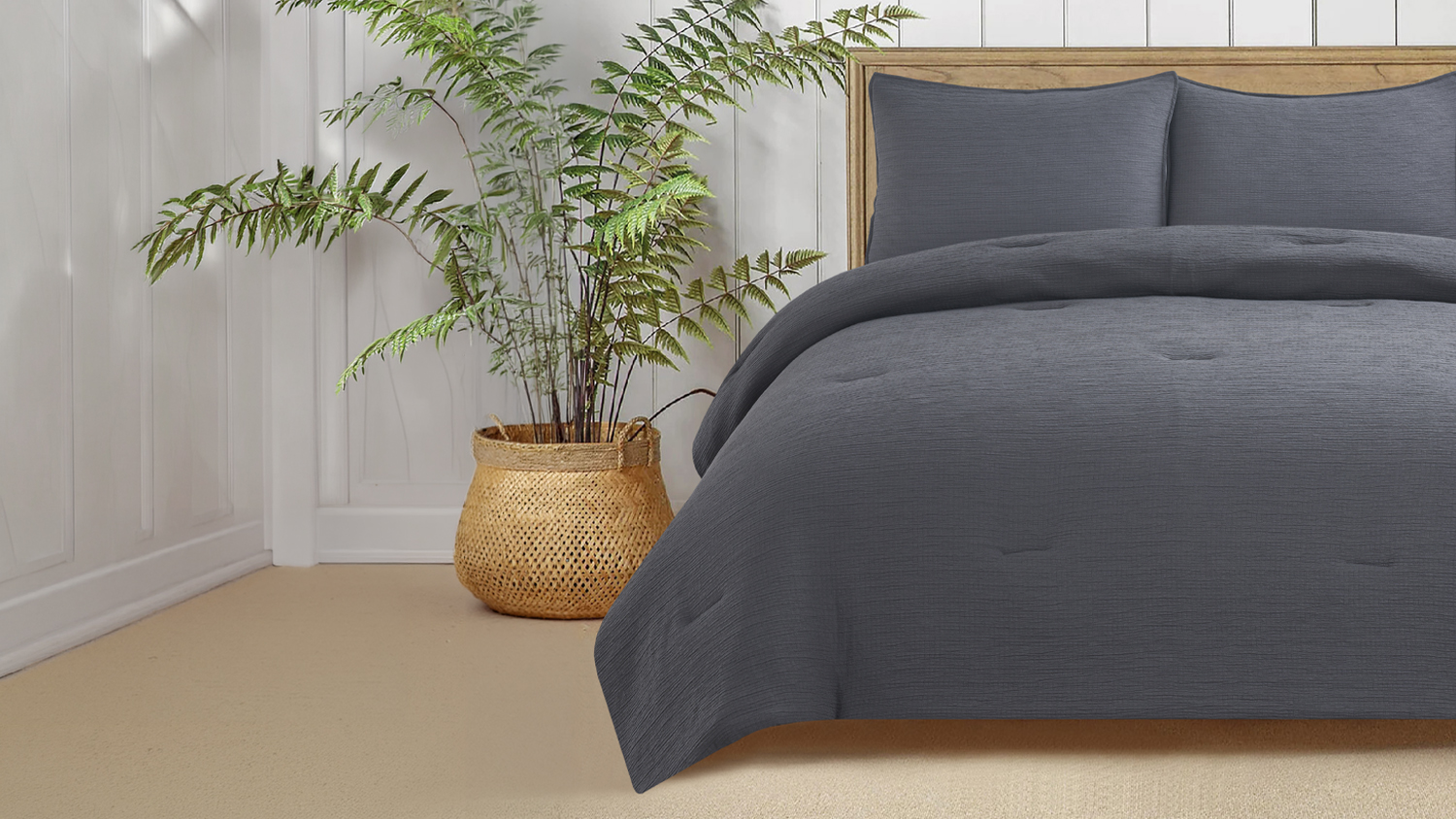 Charcoal Malmo comforter set styled on a bed with two matching pillows