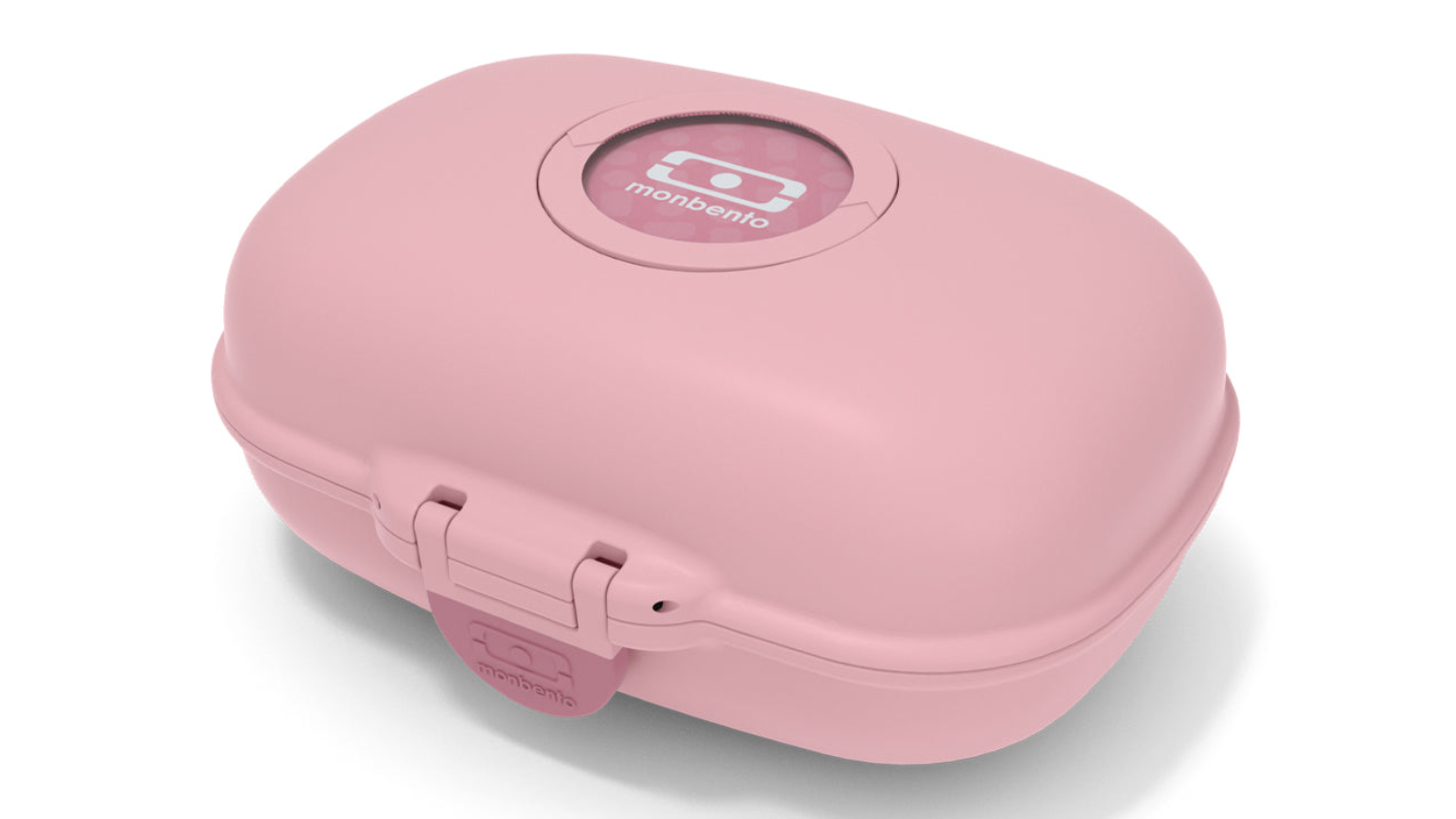 Pink blush Monbento Gram children’s snack box with rounded corners, a front latch, and a circular logo on the lid