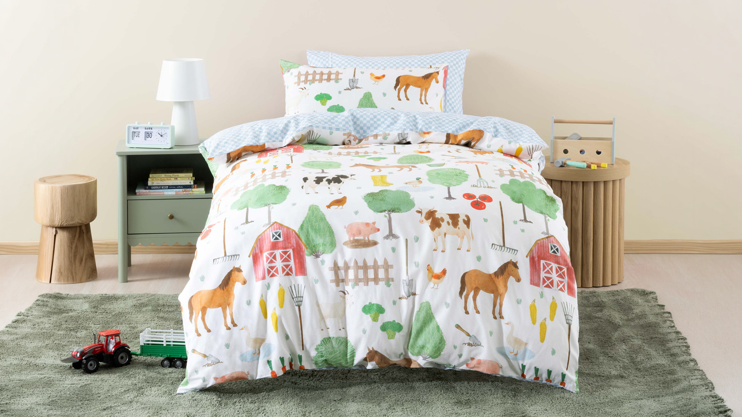 Barnyard Buddies Duvet Cover Set by Squiggles is neatly styled on a child’s bed with a playful farm print