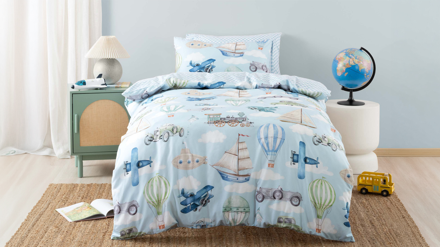 Single bed styled with a light blue kids’ duvet cover set featuring watercolour illustrations