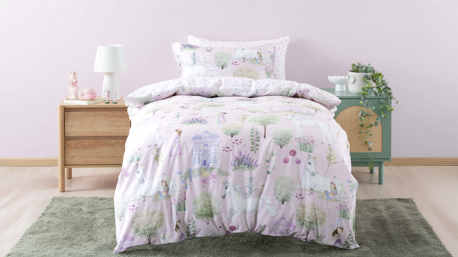 A children's bed styled with the Stardust Garden duvet set, featuring a light mauve watercolour