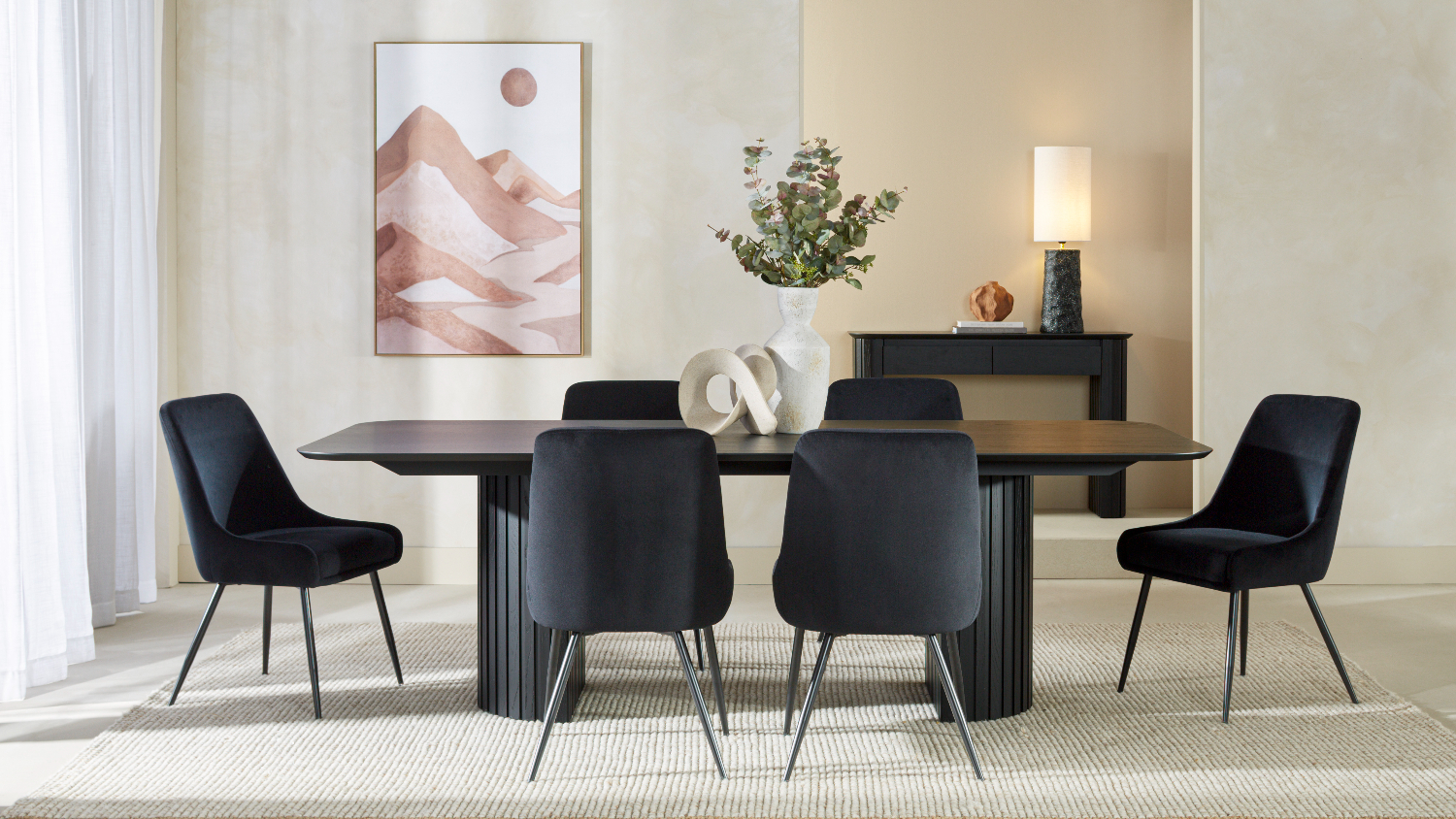Seven-piece dining suite, highlighting the dark tabletop and six cushioned black chairs