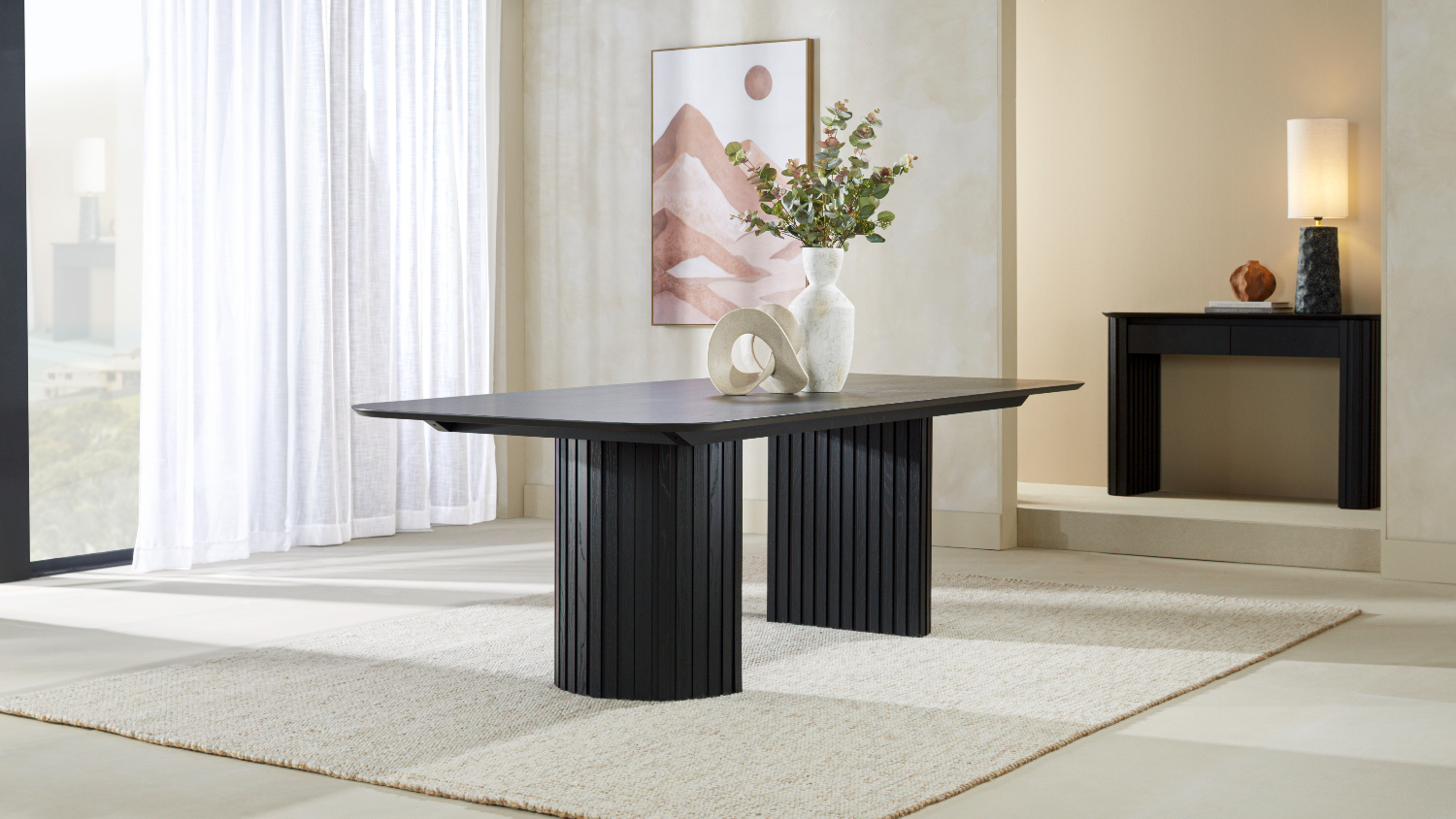 Dining table displayed without chairs, showing the rectangular top and rounded corners