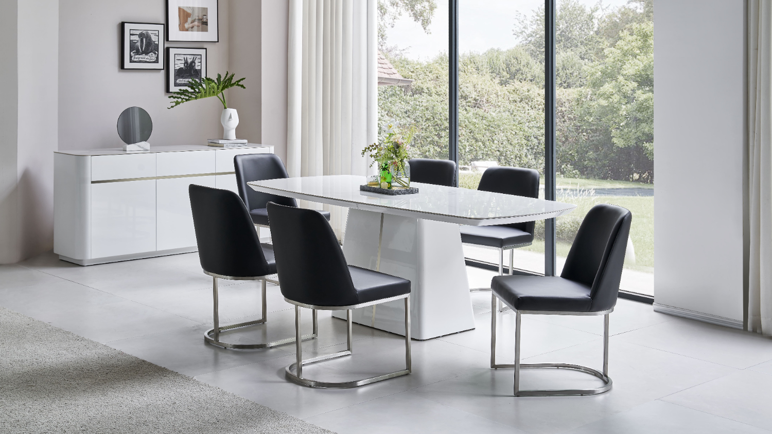 Modern dining scene featuring the Monti 7‑piece suite with a glossy white rectangular table and six black chairs