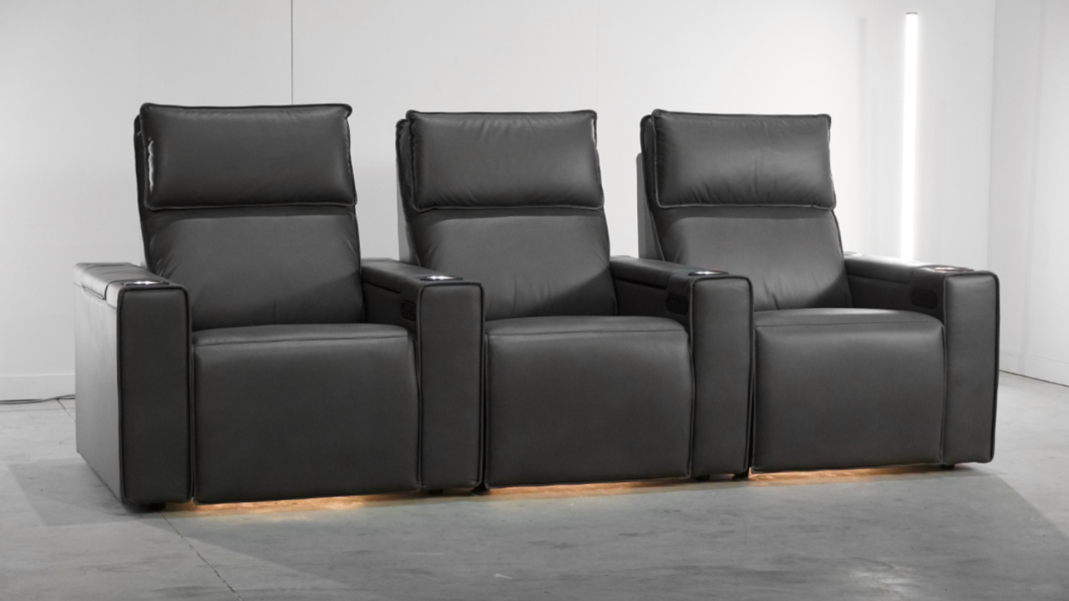 Front view of a Petra 3‑seater fabric electric recliner home theatre unit in black, featuring three cushioned seats