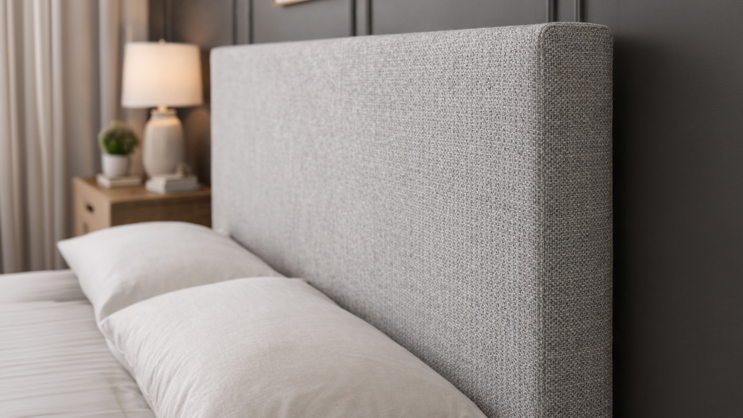Grey Austin King Upholstered Headboard with white pillows in a modern bedroom