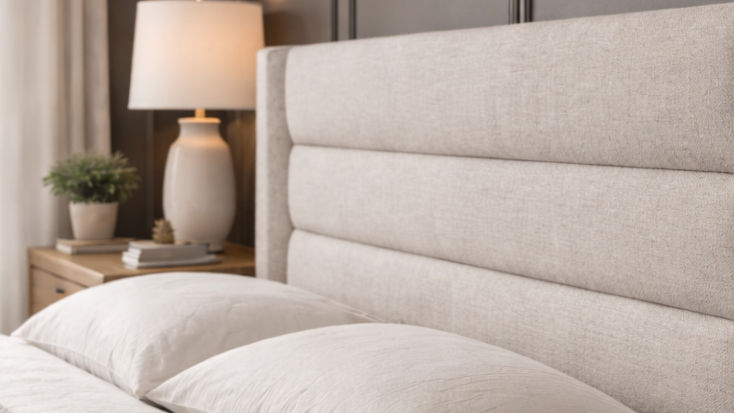 Bristol King Upholstered Headboard with pillows, bedside lamp and plant in a cosy modern bedroom