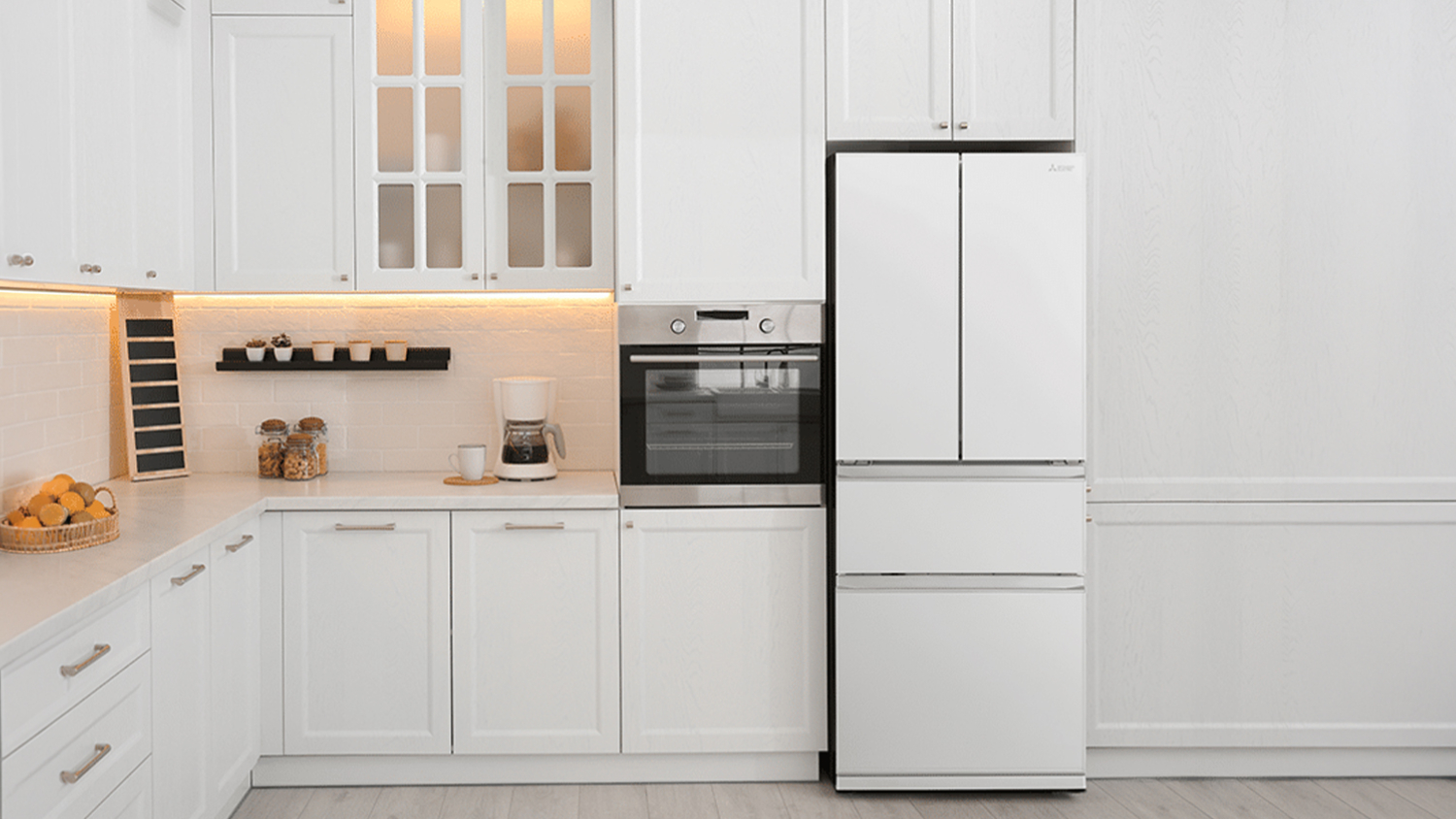 A closed white French-door refrigerator with two freezer drawers below