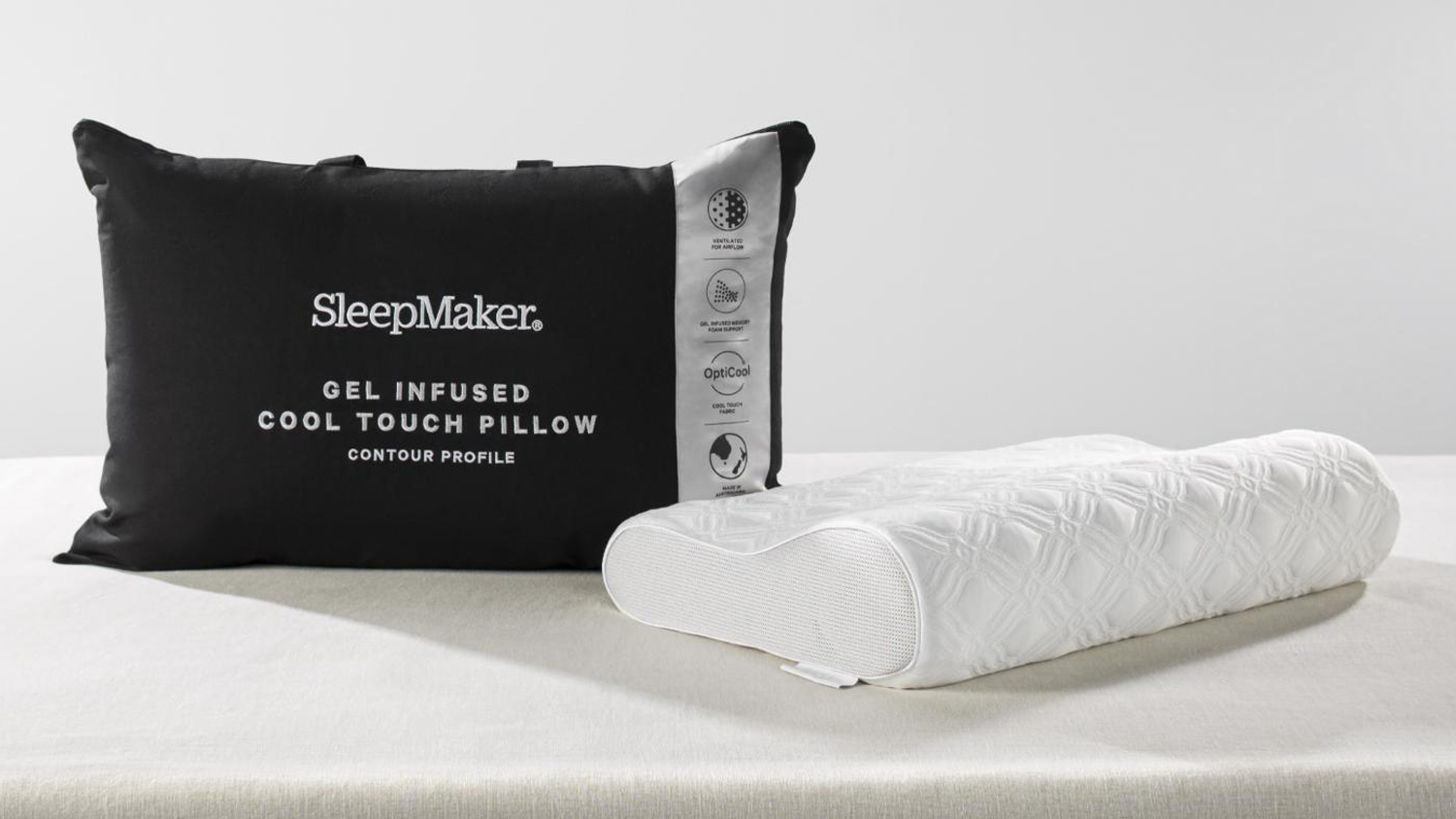 SleepMaker gel-infused cool touch contour pillow in white textured fabric next to its black zippered carrying bag
