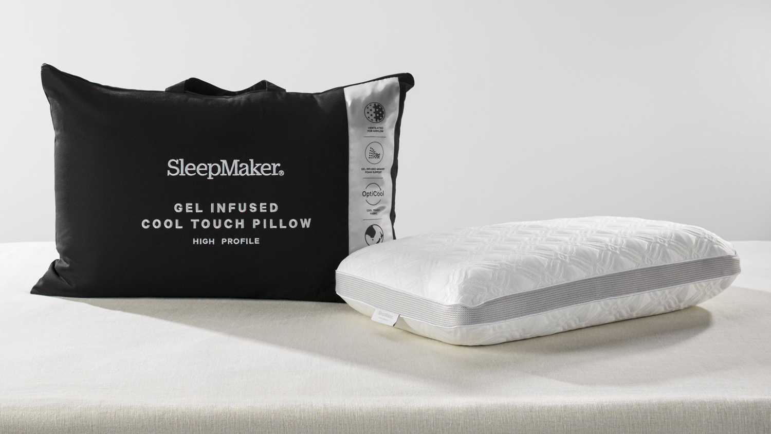 SleepMaker gel-infused cool touch high profile pillow in white textured fabric next to its black zippered carrying bag