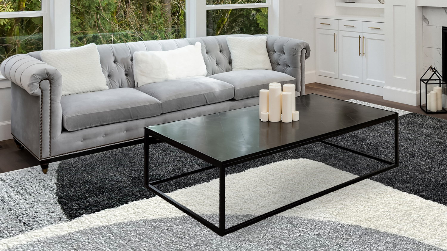 Modern living room featuring the plush Laine rug with a geometric grey, black, and white block pattern