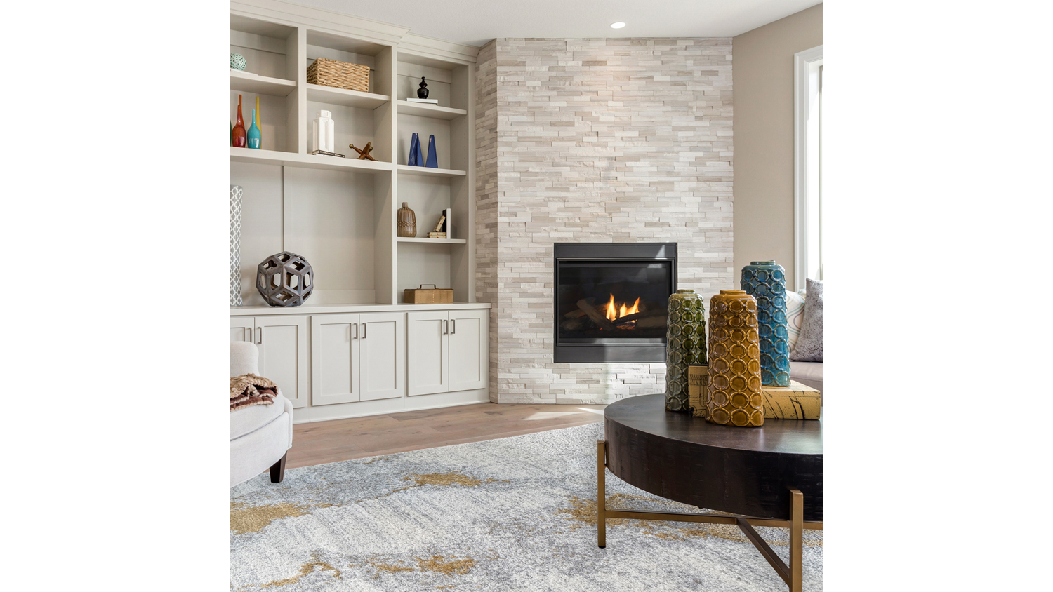 Modern living room featuring the plush Laine rug with a gold, cream, and grey colour palette