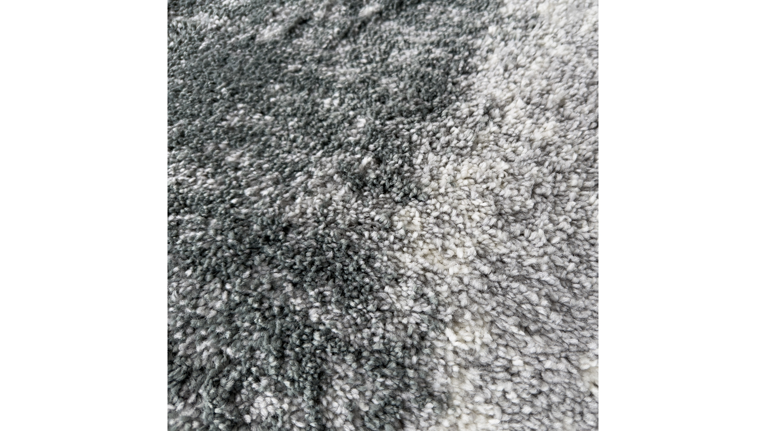 Close-up detail of a Laine area rug showing the plush, thick pile texture and contrasting grunge smoky pattern