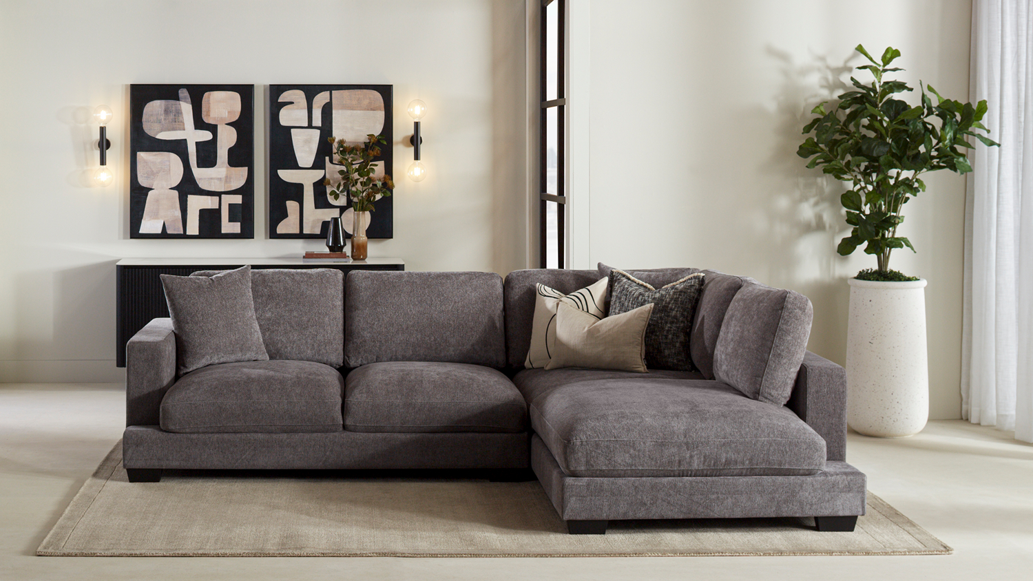 Storm fabric corner sofa with a left-hand chaise, three seat cushions, and plush backrests