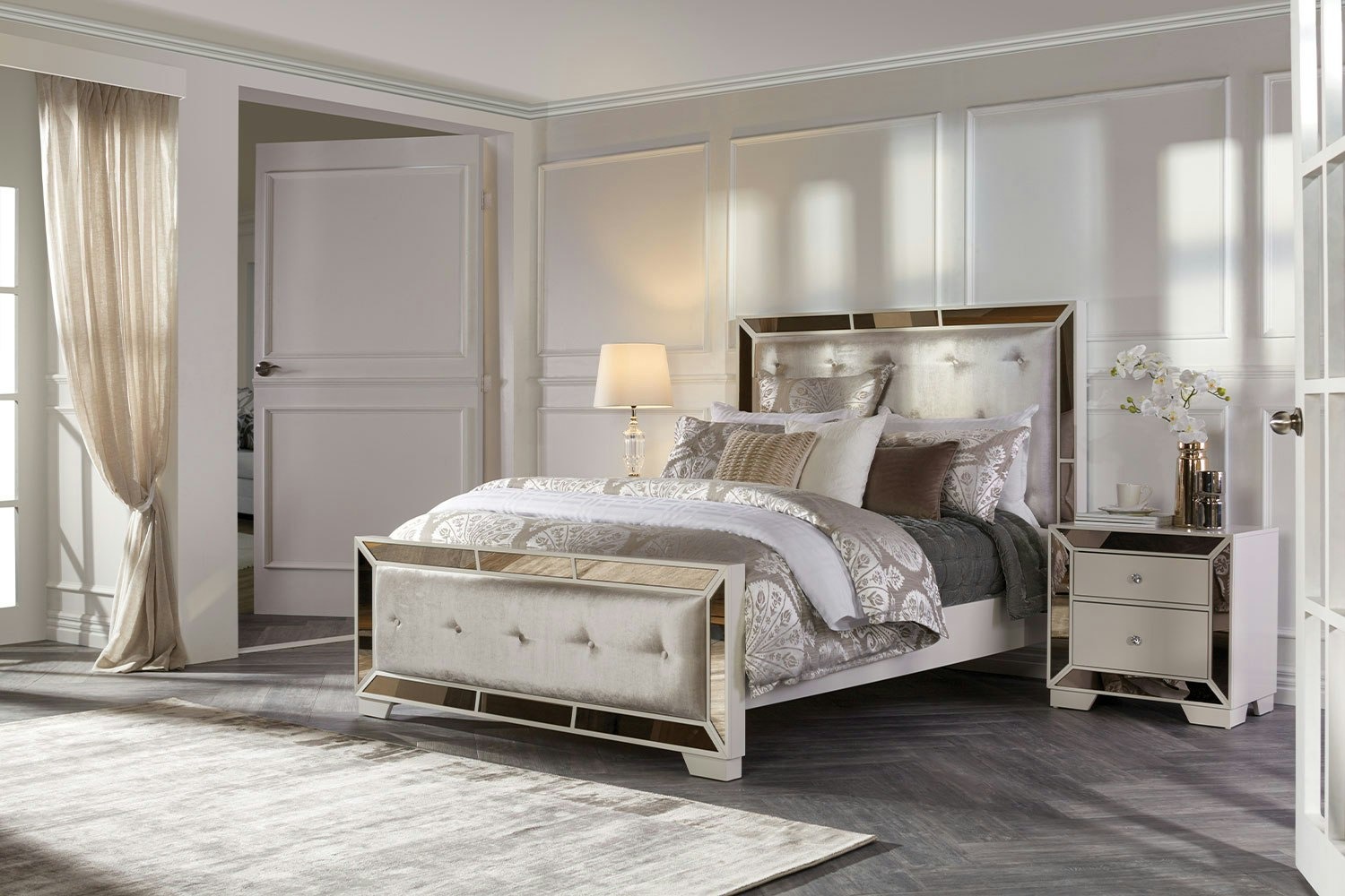 Juliette Super King Bed Frame with tufted bed, mirrored accents, white nightstand, lamp, and soft neutral decor