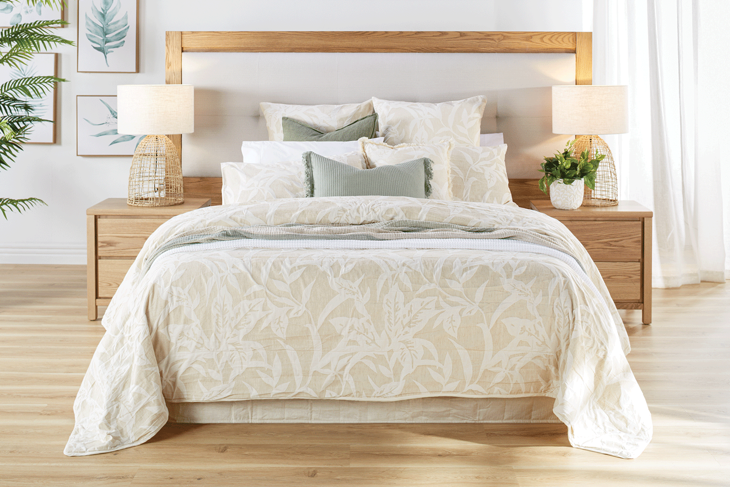 Cosy neutral bedroom styling with wood bed, soft white bedding, green accent pillows, plants, and botanical wall art Cosy neutral bedroom styling with wood bed, soft white bedding, green accent pillows, plants, and botanical wall art
